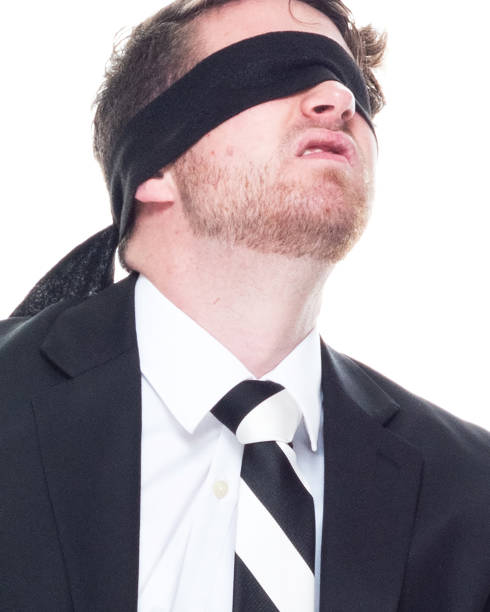 istock Handsome businessman wearing a black suit - is wearing a blindfold 1144804083
