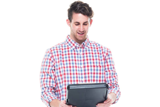 istock Attractive young man wearing a checked shirt and jeans - using a clipboard 1144804130