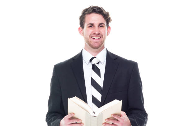 istock Good looking young businessman wearing black suit - holding book 1144804859