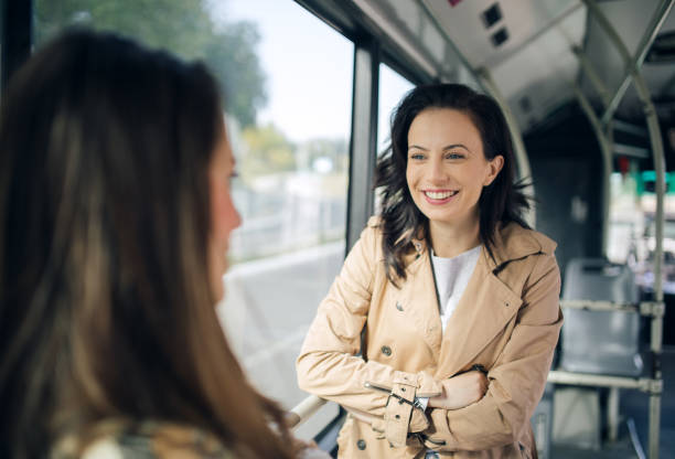 istock Two friends talking in the bus 1144804896