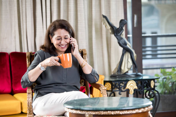 istock Senior woman using mobile phone at home 1144805288