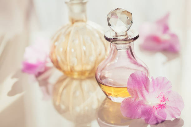 istock Spa still life with perfume and aromatic oils bottles surrounded by flowers, 1144805540