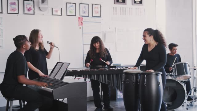Students At Performing Arts School Playing In Band At RehearsalÊ