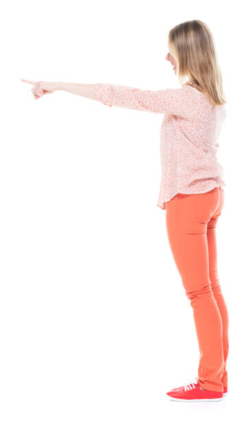 istock Good looking white female standing on white background - pointing 1144808628