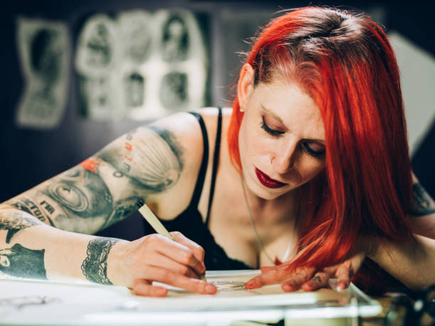 istock Tattoo artist drawing in her studio 1144810762