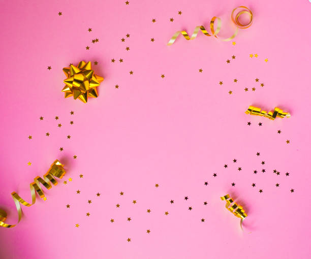 istock Golden decorations and sparkles on pink background 1144810813