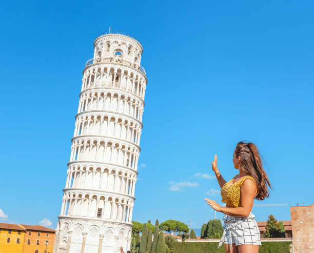 mujer turista posando con torre inclinada para instagram foto durante el viaje en pisa - leaning tower of pisa people crowd tourism fotografías e imágenes de stock