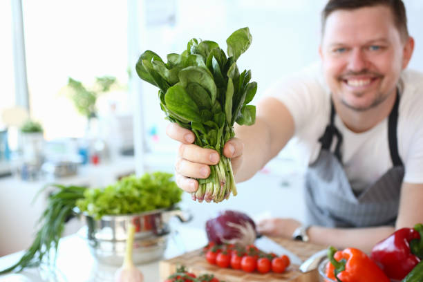 istock Chef Smile Showing Green Aromatic Herbal Bundle 1144814387