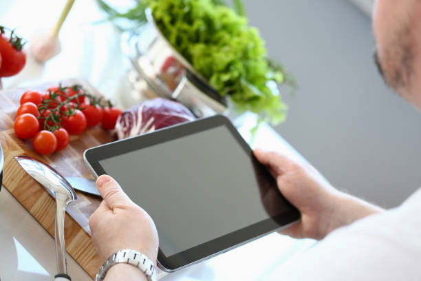 istock Chef Tablet Showing Organic Vegetable Recipe 1144814396