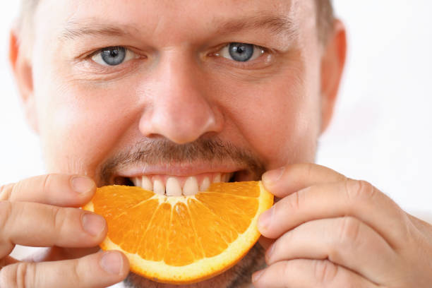 istock Smiling Chef Eating Tropical Citrus Slice Portrait 1144815002