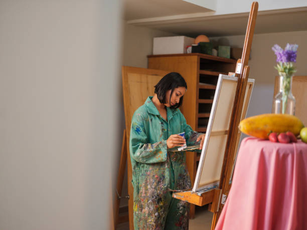 istock Female art student adding paint to a palette 1144815800