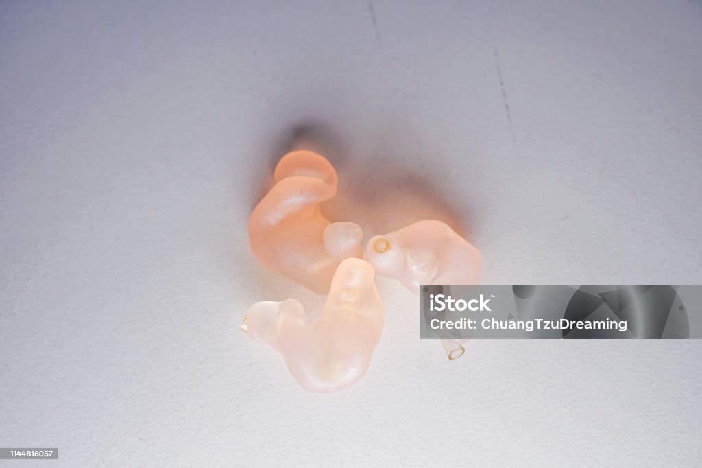 The Shell Mold used by the hearing aid. The material is silicone. Categories include Shell, Half Shell, Canal, Canal Lock, CIC, Skeleton, Open Fit. Imagery about medicine, hearing loss. AIDS Stock Photo