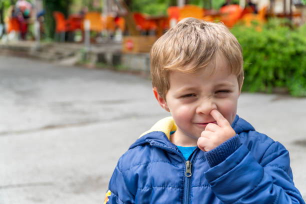 istock Small child picking his nose and making faces 1144818501