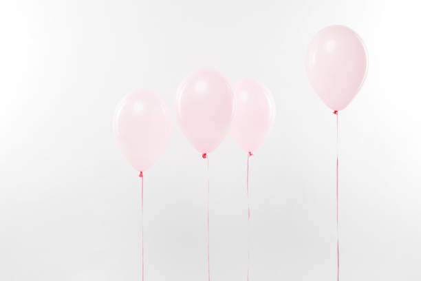 istock decorative pink air balloons on white with copy space 1144820211