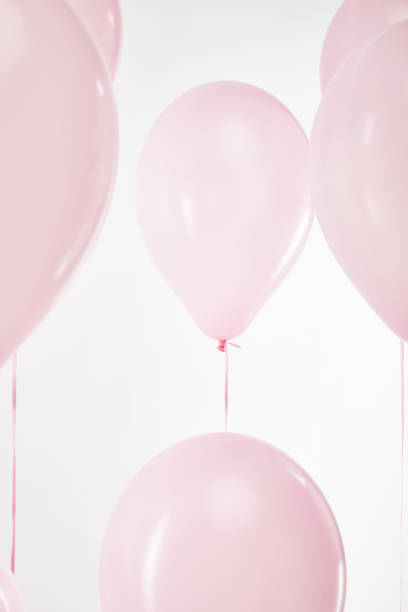 istock background with festive floating pink air balloons isolated on white 1144820225