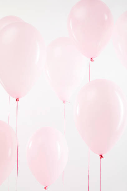 istock background with pink festive air balloons on white 1144820227
