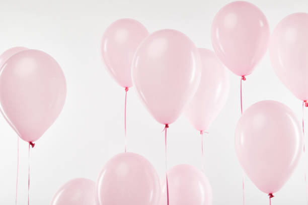 istock background with pink festive balloons isolated on white 1144820233