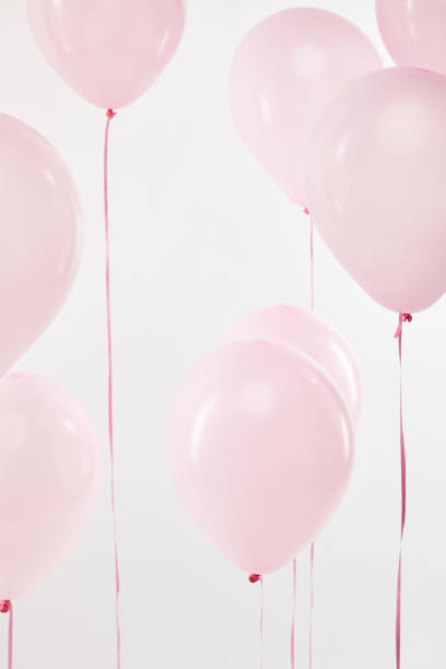 istock background with decorative floating pink air balloons isolated on white 1144820243