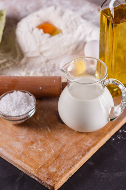 istock young woman in apron kneading dough on board 1144820528