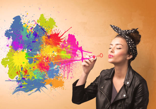 istock Cute girl blowing colorful splash graffiti 1144820612
