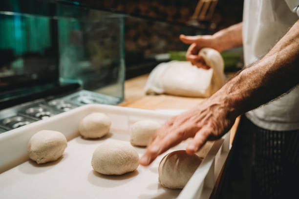 pizza chef preparing the pizza dough at the restaurant - dough sphere kneading bread imagens e fotografias de stock