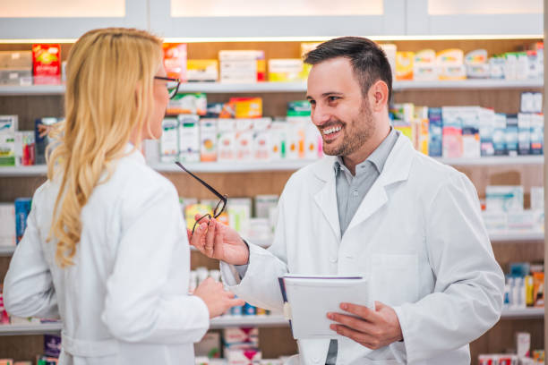 istock Two healthcare workers talking at drugstore. 1144821401
