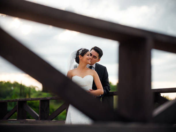 istock Affectionate groom kissing bride on cheek 1144822564