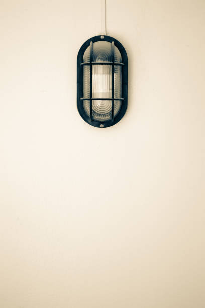 Vintage wall lamp installed outside of home close up.  processed in sepia color tone.