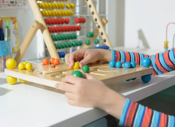 istock Cute little child is playing with educational toys, close up 1144823764