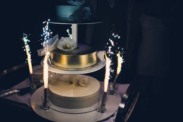 istock The wedding cake with fireworks stand on the table in restaurant. 1144824425