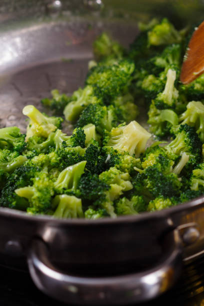 istock young woman in a gray apron roasts cauliflower broccoli 1144826562