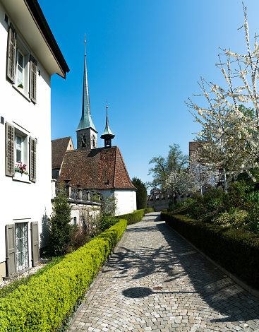 footpath leading to Sankt Oswald church in the city of Zug in Switzerland on a beautiful spring day
