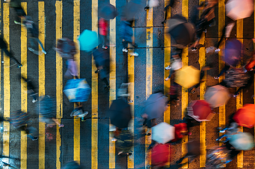 Top view of people crossing a very busy crossroads in Mong Kok district Hong Kong in China
