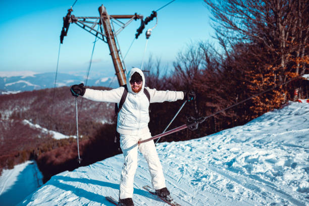 Male Skier Climbing A Hill