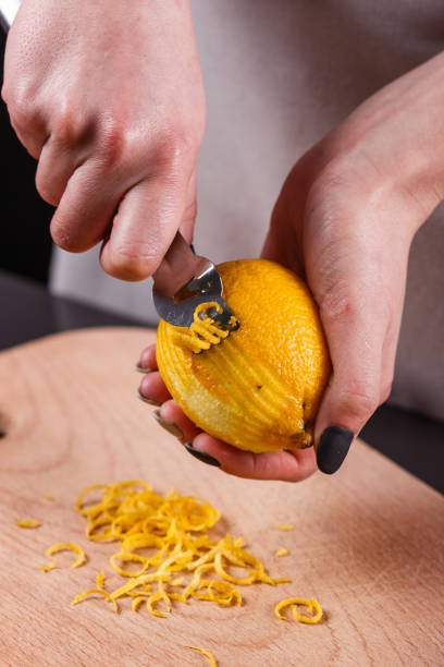 istock young woman in a gray aprons cuts lemon zest 1144828395