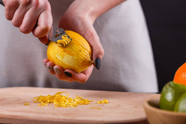 istock young woman in a gray aprons cuts lemon zest 1144828404