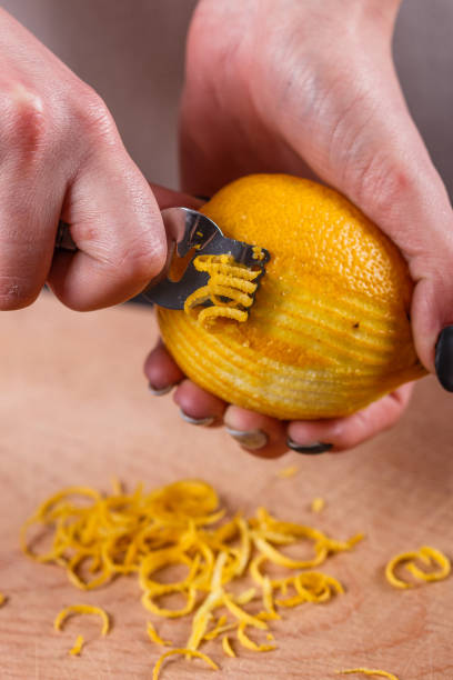 istock young woman in a gray aprons cuts lemon zest 1144828427