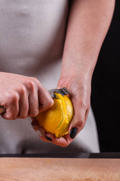 istock young woman in a gray aprons cuts lemon zest 1144828437