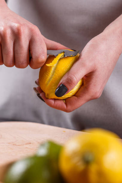istock young woman in a gray aprons cuts lemon zest 1144828438