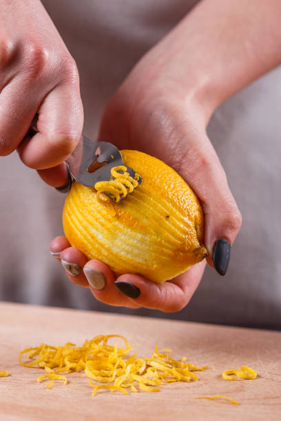 istock young woman in a gray aprons cuts lemon zest 1144828441