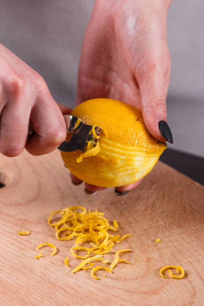 istock young woman in a gray aprons cuts lemon zest 1144828446