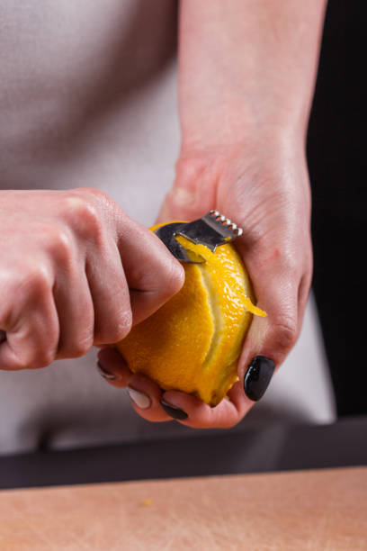 istock young woman in a gray aprons cuts lemon zest 1144828459