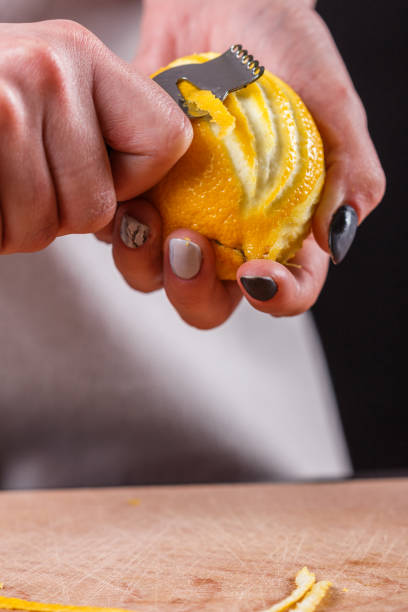 istock young woman in a gray aprons cuts lemon zest 1144828489