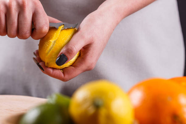 istock young woman in a gray aprons cuts lemon zest 1144828511
