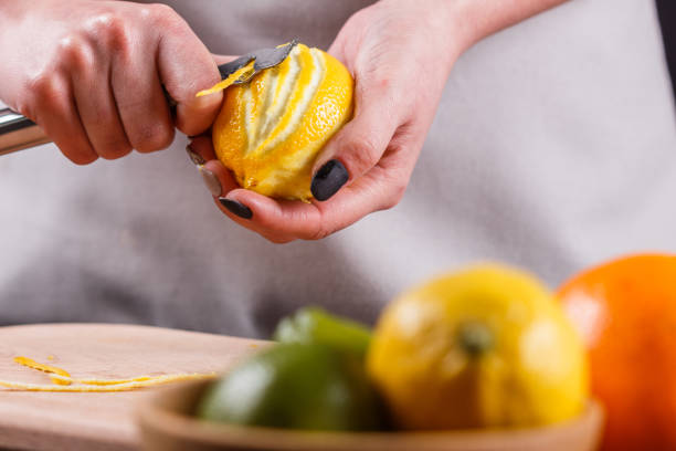 istock young woman in a gray aprons cuts lemon zest 1144828543