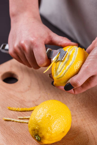 istock young woman in a gray aprons cuts lemon zest 1144829073