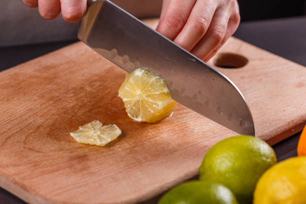 istock young woman in a gray aprons cut lemon 1144829218