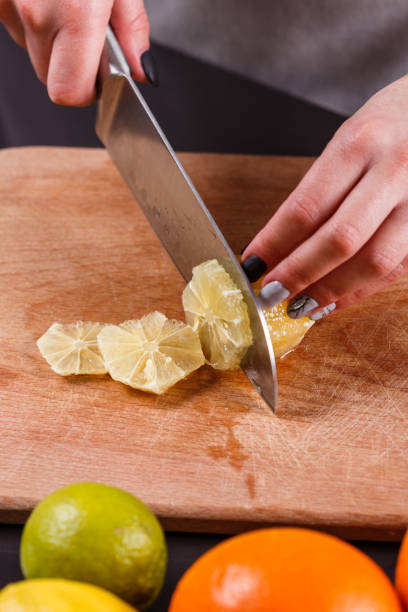 istock young woman in a gray aprons cut lemon 1144829227