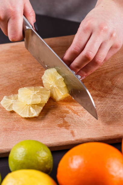 istock young woman in a gray aprons cut lemon 1144829289