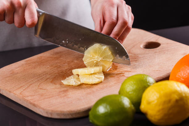 istock young woman in a gray aprons cut lemon 1144829296